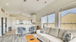 A modern kitchen with white cabinets, a microwave, and a stainless steel refrigerator. - Inviting Atlantic Beach Townhome ~ 1/2 Mi to Ocean (Atlantic Beach)