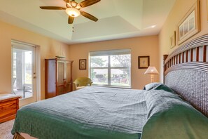 A bedroom with a bed, a ceiling fan, a window, and a door. - Waterfront Lake Placid Home w/ Yard & Boat Launch! (Lake Placid)