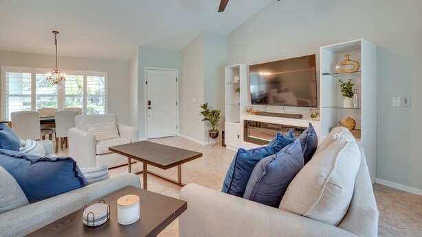 A modern living room with a sofa, coffee table, and TV stand. - Cheery Fort Myers Vacation Rental w/ Private Pool! (Fort Myers)