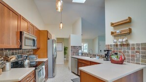 A modern kitchen with wooden cabinets, stainless steel appliances, and a large island. - Cheery Fort Myers Vacation Rental w/ Private Pool! (Fort Myers)