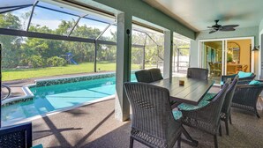 A covered patio with a pool, outdoor furniture, and a view of the backyard. - Cheery Fort Myers Vacation Rental w/ Private Pool! (Fort Myers)