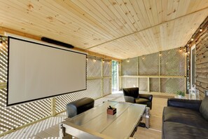 A modern meeting room with a glass table, leather chairs, and a large white screen. - Private Cabin Rental in the Catskill Mountains! (Hamden)