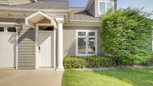 A residential house with a front garage, a covered entryway, and a well-maintained lawn. - Jackson Lakefront Getaway w/ Balcony, Dock Access (Jackson)