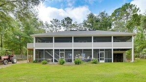 A two-story building with a covered patio area and a visible staircase leading to the upper floor. - Hawthorne Vacation Rental w/ Access to Cue Lake (Hawthorne)