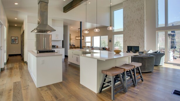 A spacious kitchen with a central island, wooden flooring, and pendant lighting. - Avon Vacation Rental w/ Hot Tub & Mountain Views! (Avon)
