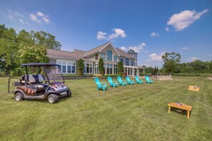 A house with a large lawn, a golf cart, and several chairs. - Jackson Lakefront Getaway: Boat Dock, Porch, Patio (Jackson)