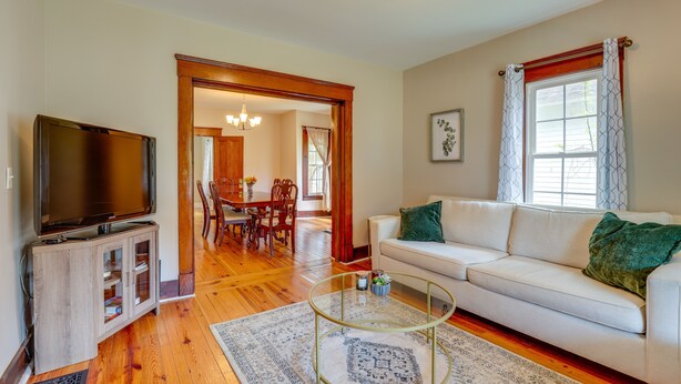 A living room with a TV, sofa, and coffee table.