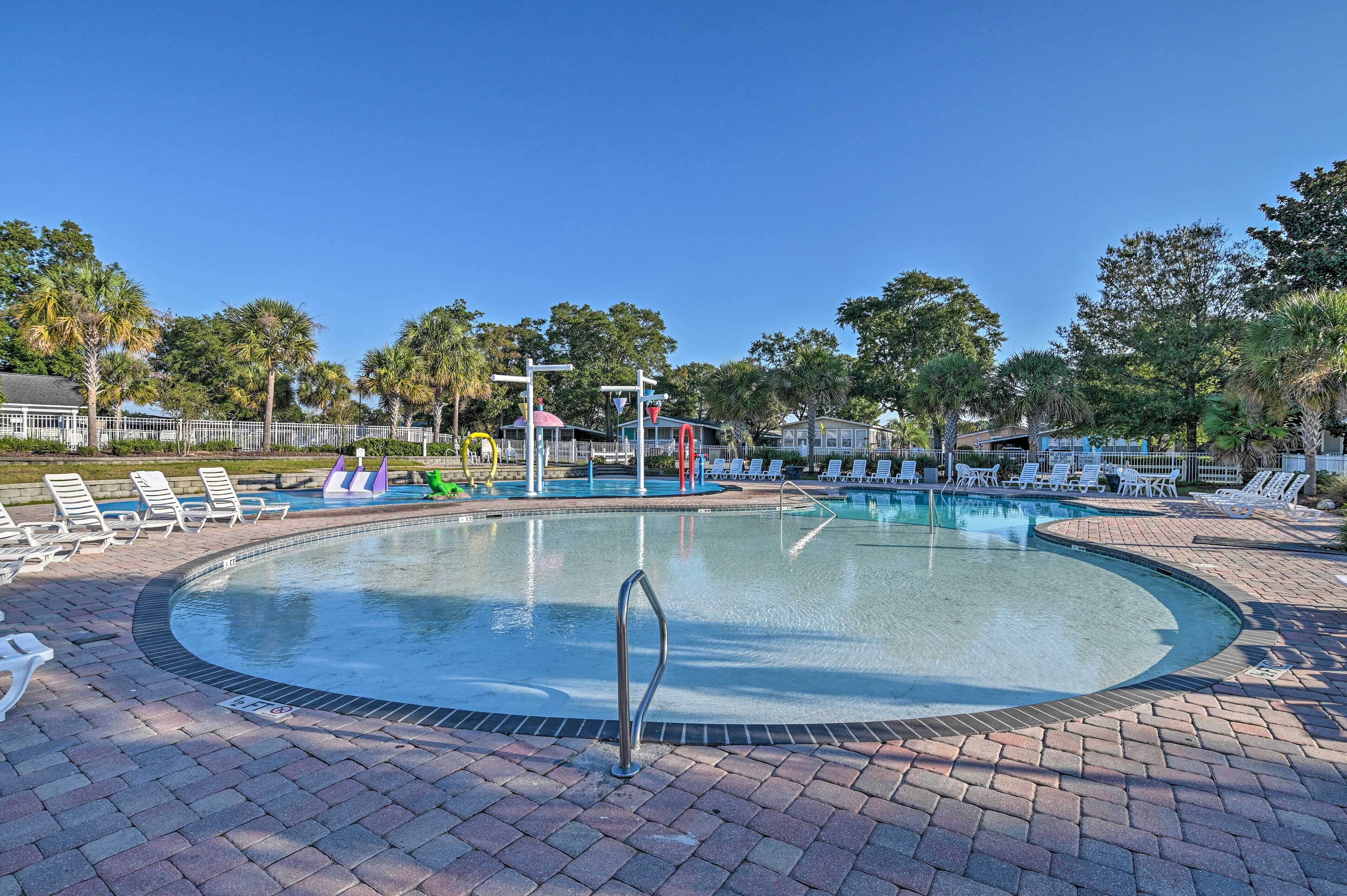 A circular pool with lounge chairs and a lifeguard stand.