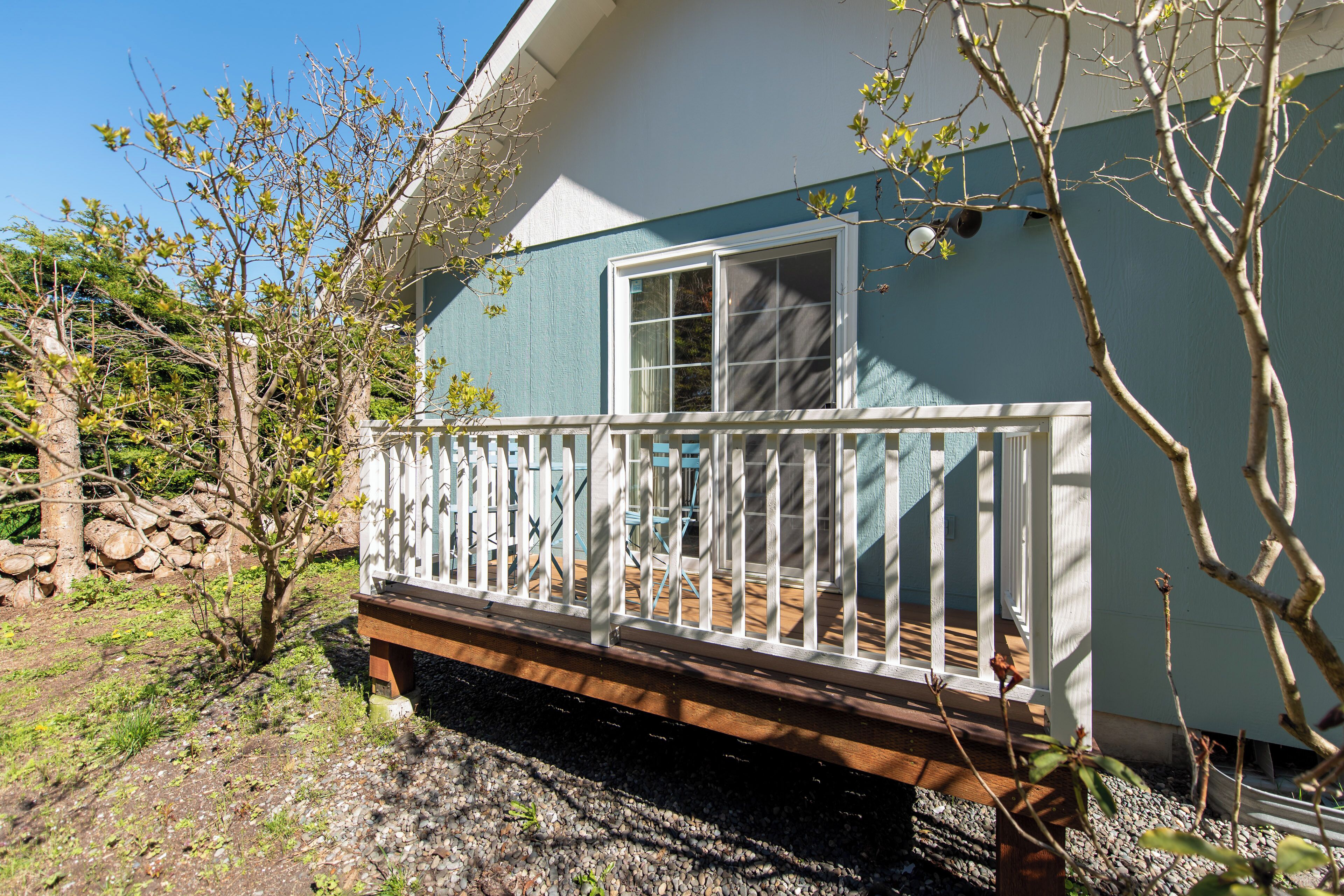 A house with a white porch and a blue exterior wall.