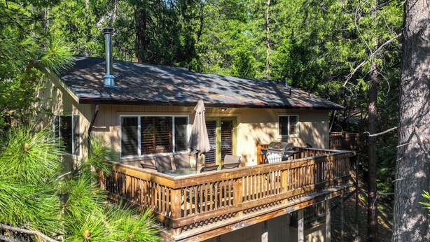 A cabin with a deck, surrounded by trees. - Cozy Mi-wuk Village Cabin w/ Deck! (Mi-Wuk Village)