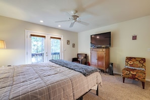 A bedroom with a bed, a ceiling fan, a TV, a chair, and a cabinet. - Cozy Mi-wuk Village Cabin w/ Deck! (Mi-Wuk Village)