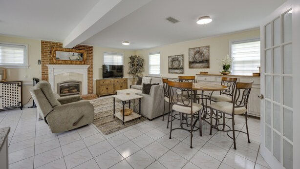A spacious living room with a fireplace, a dining area with a table and chairs, and a kitchen in the background. - Mechanicsville Vacation Rental ~ 8 Mi to Richmond (Mechanicsville)