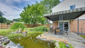 A backyard with a pond, patio furniture, and a covered seating area. - Mechanicsville Vacation Rental ~ 8 Mi to Richmond (Mechanicsville)