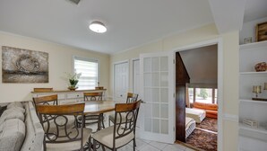 A dining area with a table and chairs, a sofa, and a view of a bedroom with a bed and a window. - Mechanicsville Vacation Rental ~ 8 Mi to Richmond (Mechanicsville)