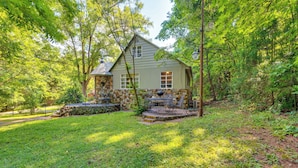 A house with a stone foundation, a porch with outdoor furniture, and a well-maintained lawn. - Salisbury Cottage ~ 7 Mi to High Rock Lake! (Salisbury)