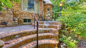 A stone staircase leading to a house with a window and a lantern. - Salisbury Cottage ~ 7 Mi to High Rock Lake! (Salisbury)