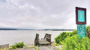 A wooden dock leading to a body of water with a sign indicating a public walkway and closure times. - Massachusetts Vacation Rental: 5 Mi to Fall River (Somerset)