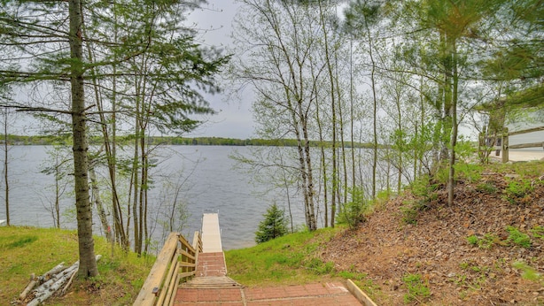 A wooden staircase leading to a dock by a lake, surrounded by trees. - Lakefront Wisconsin Home w/ Boat Dock & Fire Pit! (Townsend)