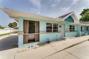 A single-story house with a light blue exterior, beige trim, and a sloped roof.