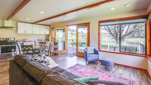 A spacious living area with a sofa, a dining table, and a kitchen in the background. - Julian Cottage Stay w/ Near Wildlife & Wineries (Julian)