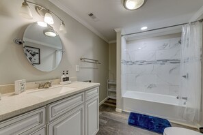 A bathroom with a large mirror, vanity, sink, and bathtub. - Pet-friendly Lexington Vacation Rental on Lake! (Lexington)