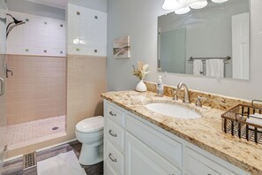 A bathroom with a shower, toilet, sink, and vanity. - Spacious Lake Norman Retreat w/ Boat Ramp! (Sherrills Ford)