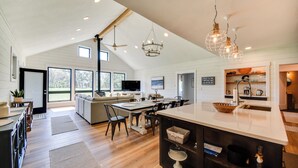 A spacious kitchen with a large island, wooden flooring, and modern lighting fixtures. - Stunning Chesapeake Bay Farmhouse w/ Dock & Kayaks (Machipongo)