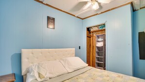 A bedroom with a bed, a wooden nightstand, a ceiling fan, and a wardrobe. - French Lick Getaway w/ Deck, Grill & Fire Pit! (French Lick)
