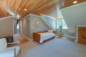 A bedroom with a sloped ceiling, a bed, a radiator, and a window. - Marlboro Escape: 9 Mi to Mount Snow Resort! (Wilmington)