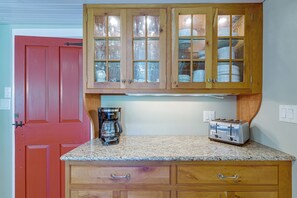 A kitchen with wooden cabinets, a coffee maker, and a toaster. - Marlboro Escape: 9 Mi to Mount Snow Resort! (Wilmington)