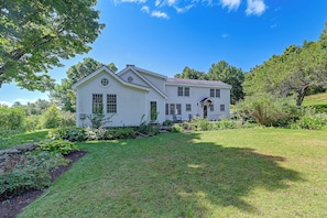 A two-story white house with a well-maintained lawn and garden. - Marlboro Escape: 9 Mi to Mount Snow Resort! (Wilmington)