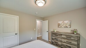 A bedroom with two white doors, a wooden dresser, and a painting on the wall. - Serene Dry Ridge Vacation Rental w/ Nearby Fishing (Dry Ridge)