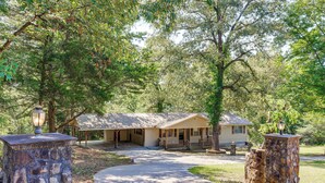 A lodge with a stone entrance, a covered porch, and a pathway leading to the main building.
