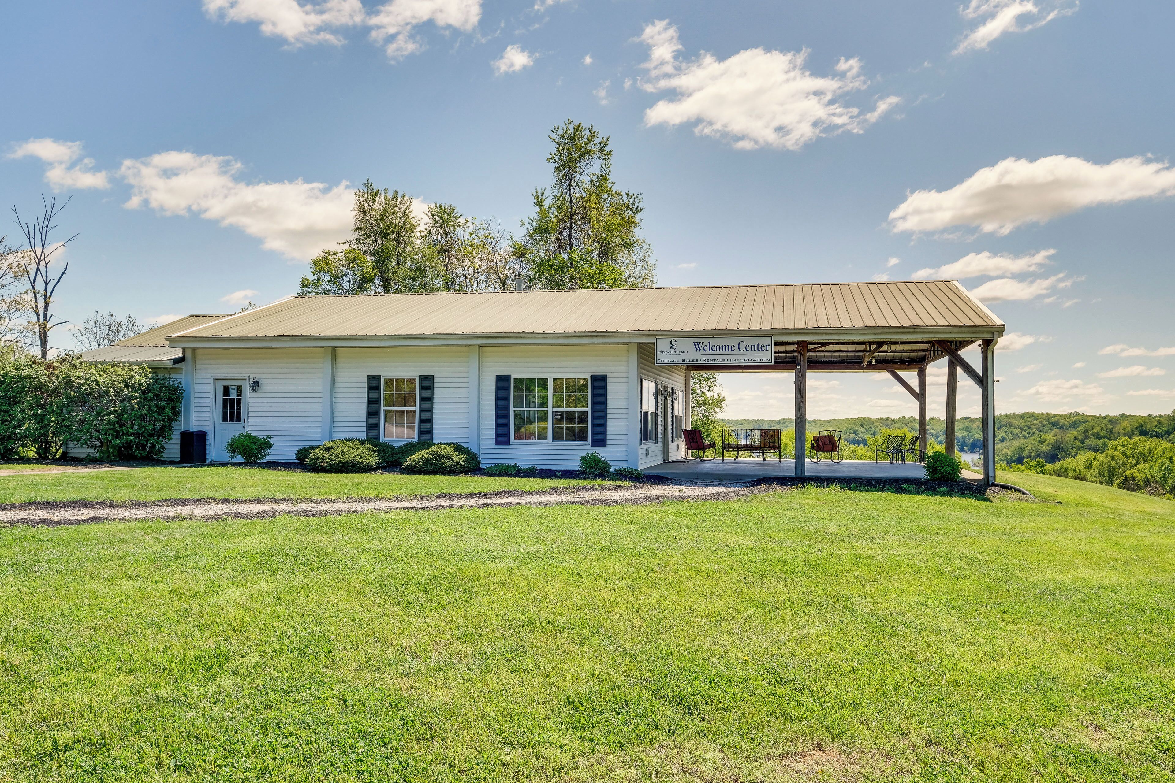 A single-story building with a covered porch and a sign reading "Welcome Center."