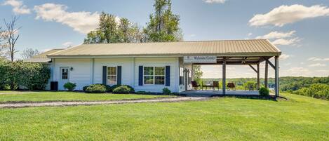 A single-story building with a covered porch and a sign reading "Welcome Center."