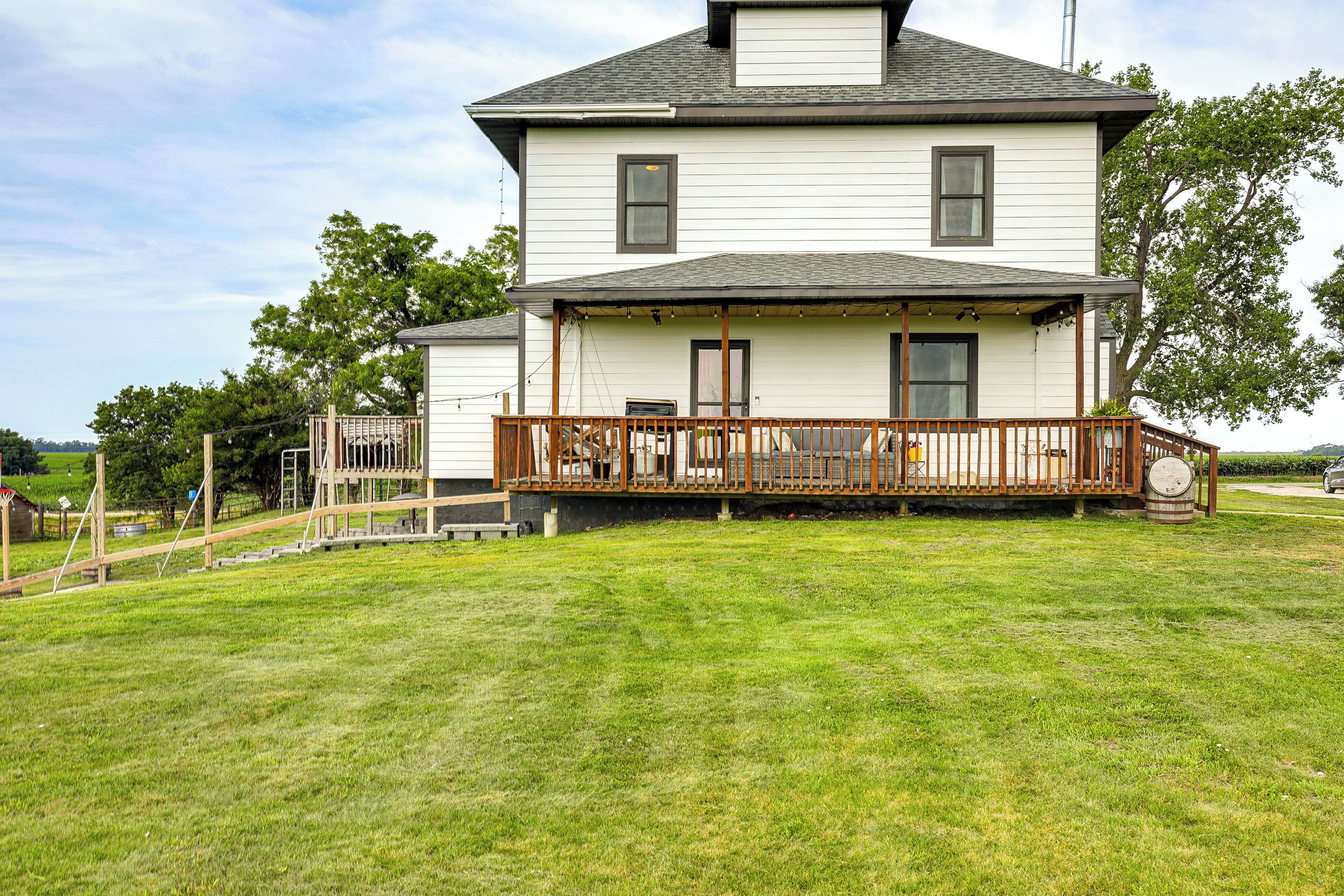 A two-story house with a wooden deck and a garage.