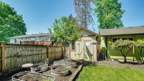 A backyard with raised garden beds, a wooden fence, and a small shed. - Vancouver Vacation Rental ~ 16 Mi to Portland! (Vancouver)