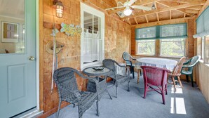 A wooden interior with a dining area, ceiling fan, and windows. - Georgetown Vacation Rental: Gas Grill & Near Beach (Georgetown)