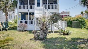 A two-story house with a balcony, a front porch, and a staircase leading to the upper floor. - Walk to Water: Coastal-chic Home Near Myrtle Beach (North Myrtle Beach)