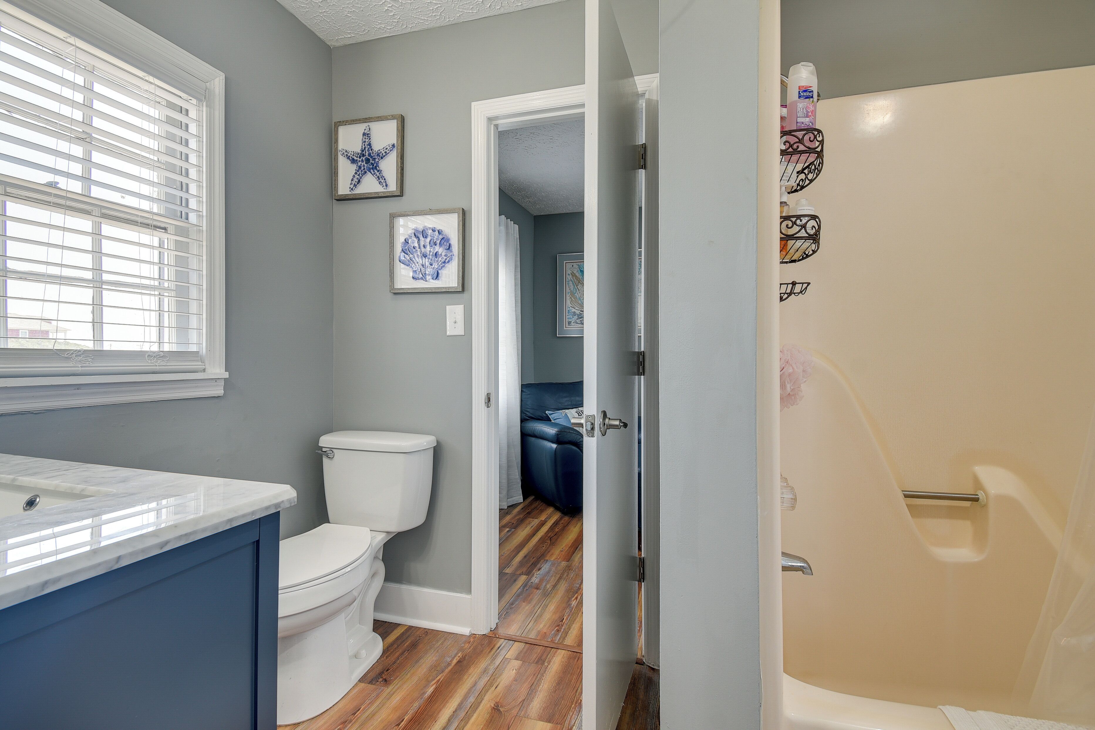 A bathroom with a toilet, a sink, and a shower.