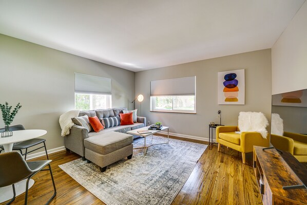 Relax in this stylish living room with a gray sofa, armchair, and coffee table.