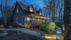 A two-story house with a porch, surrounded by trees. - Near Highlands: 36-acre Scaly Mountain Lodge (Scaly Mountain)