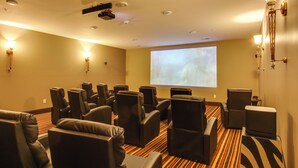A hotel room with a large screen, multiple reclining chairs, and a carpeted floor. - Loretto Vacation Rental w/ Community Resort Perks (Loretto)