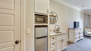 A compact kitchen with a built-in microwave, refrigerator, and a sink. - Loretto Vacation Rental w/ Community Resort Perks (Loretto)