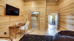 A wooden interior with a TV, desk, chair, and a bed. - Burkesville Cabin, 3 Mi to Dale Hollow Lake! (Burkesville)