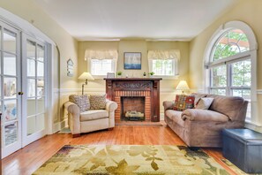 A cozy living room with a fireplace, two sofas, and a rug. - Turtle Cove Bay Beach House ~ 13 Mi to Buffalo! (Lake View)