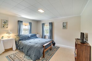 A bedroom with a bed, nightstands, a desk, and a TV. - Walworth Home w/ Hot Tub - Near Golf Courses! (Walworth)