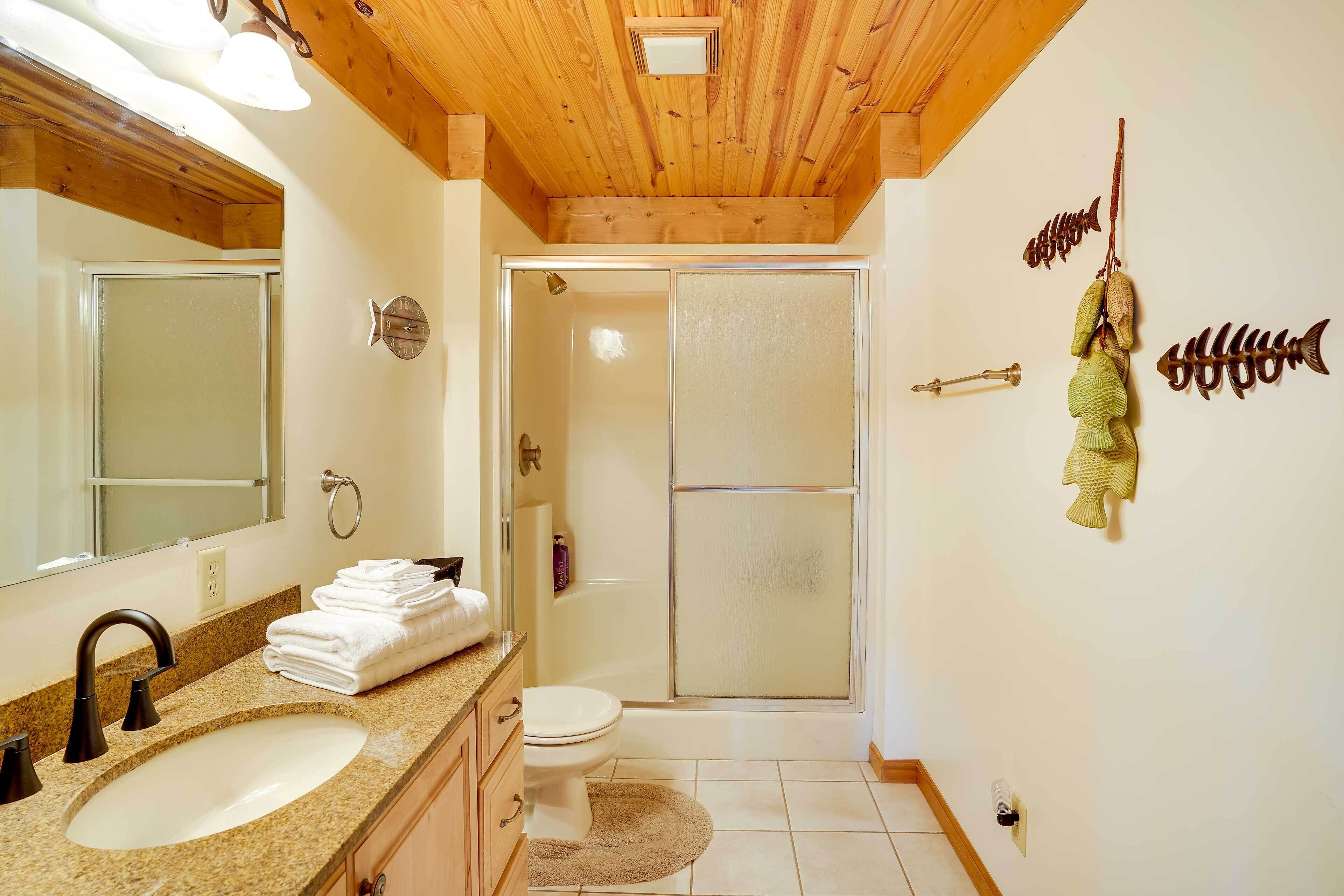 A bathroom with a sink, toilet, and shower.