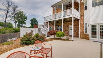 Enjoy a tranquil retreat with a covered patio featuring a round table and two chairs.