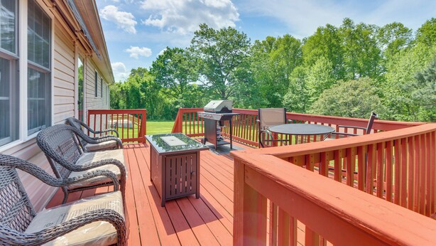 A wooden deck with wicker furniture, a grill, and a table. - Peaceful Chatham Home w/ Grill & Deck (Chatham)
